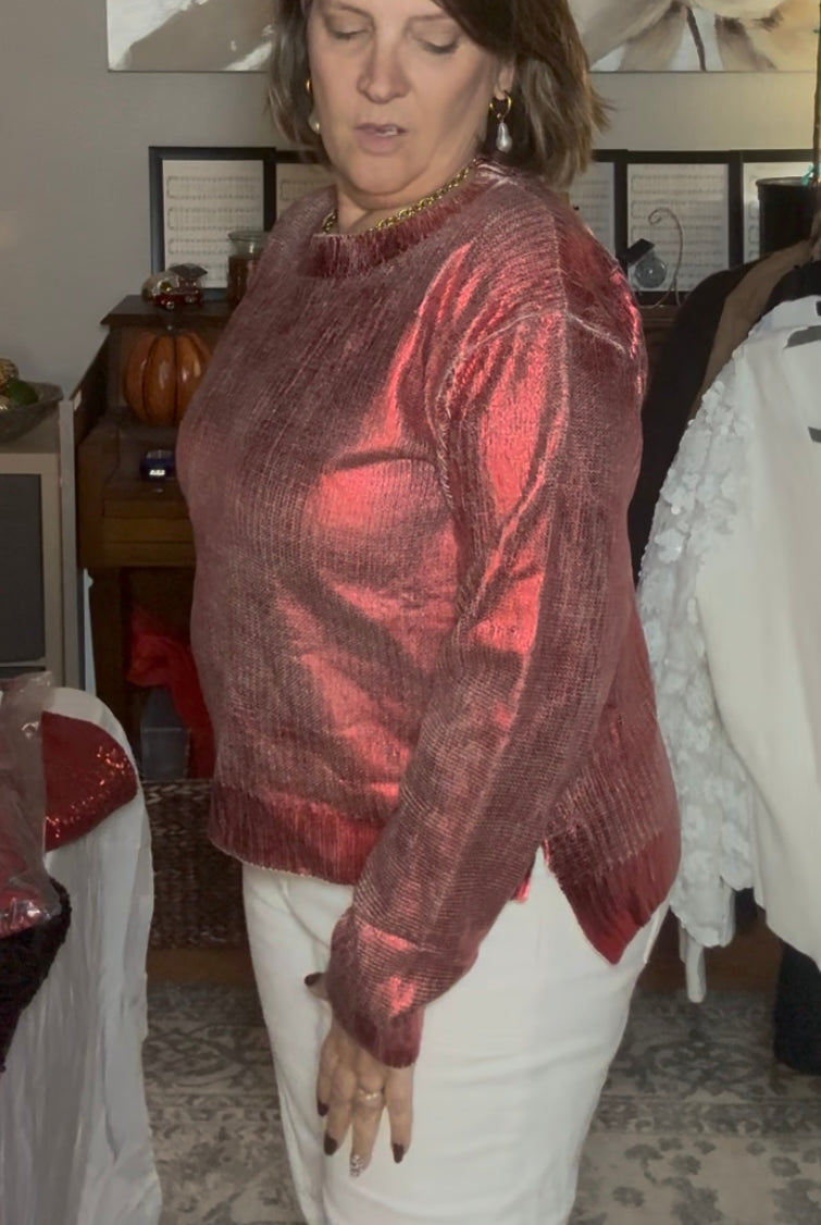 Woman wearing a red metallic jacket and white pants in an indoor setting.