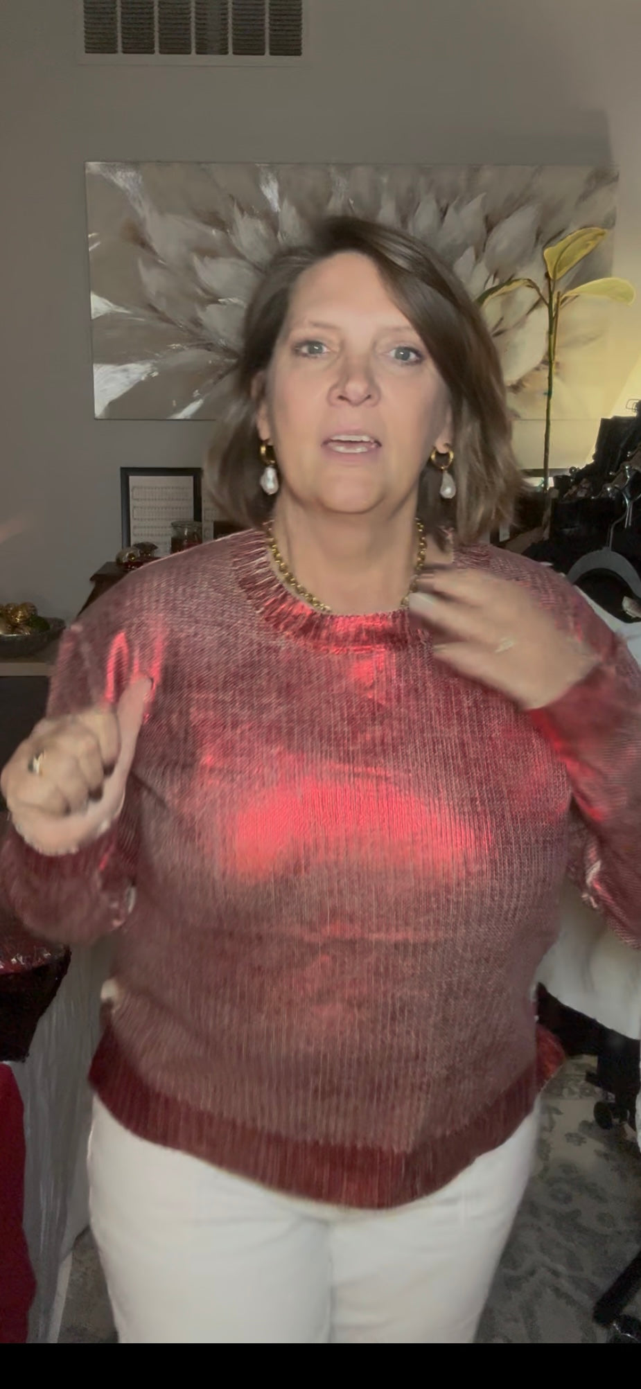Woman wearing a sheer red sweater in an indoor setting