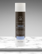 Body wash bottle for men on a marble surface with a gray background