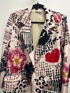 Patterned jacket with floral and heart designs on a mannequin against a white background